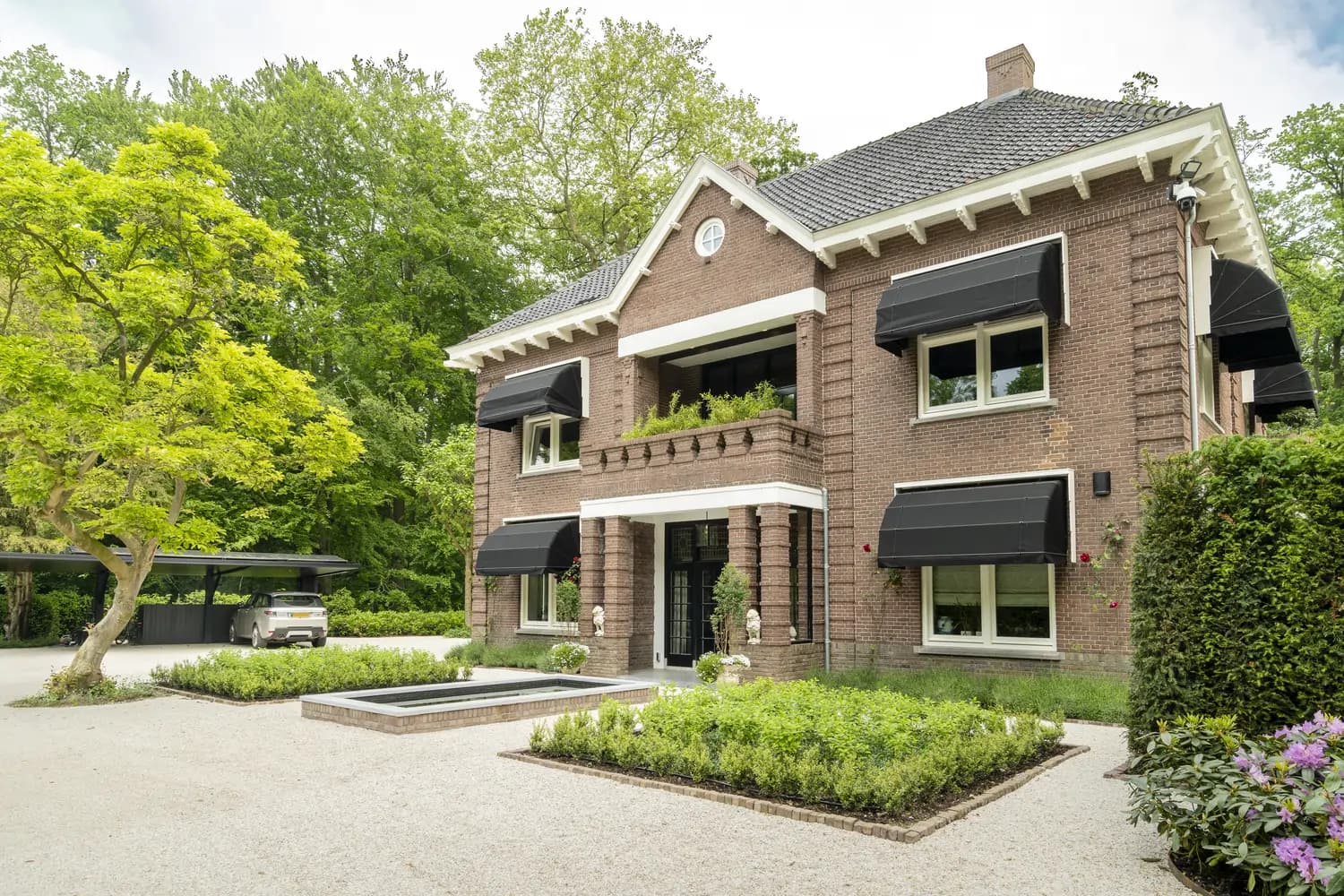 Classic Dutch brick villa with elegant front garden and water feature