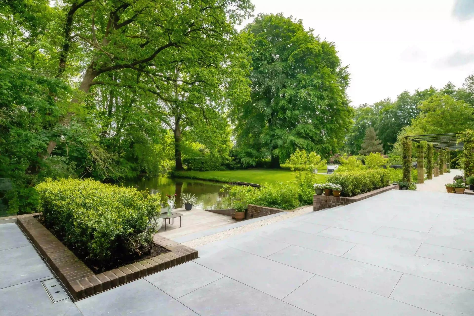 Modern minimalist garden with natural pond and contemporary design