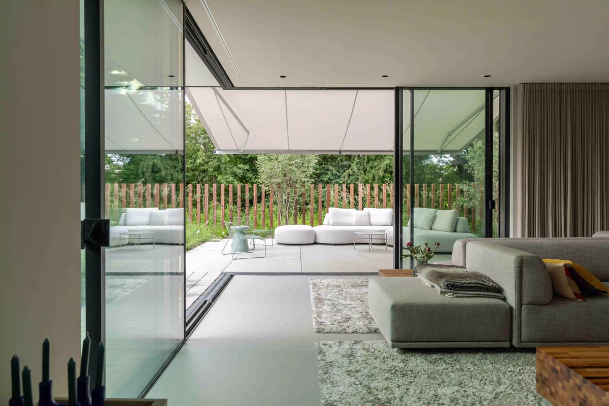 Interior view looking out to garden through open sliding doors