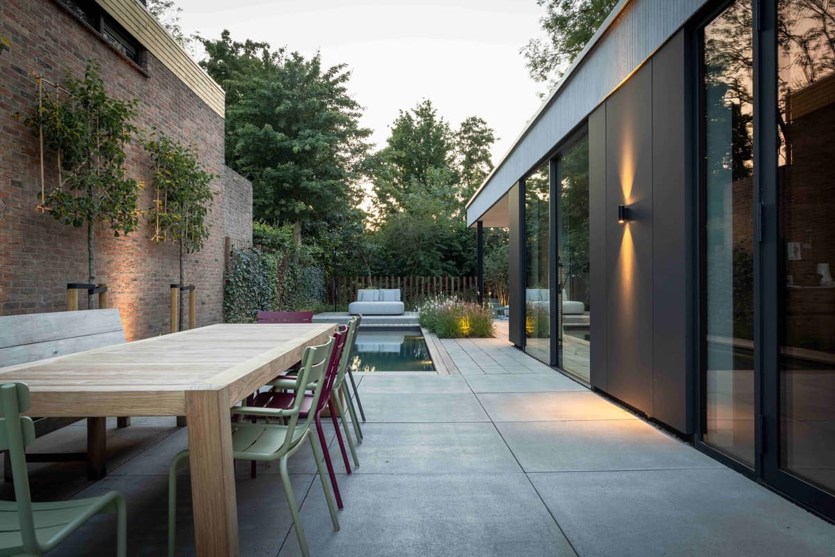 Evening dining area with colorful chairs and pool