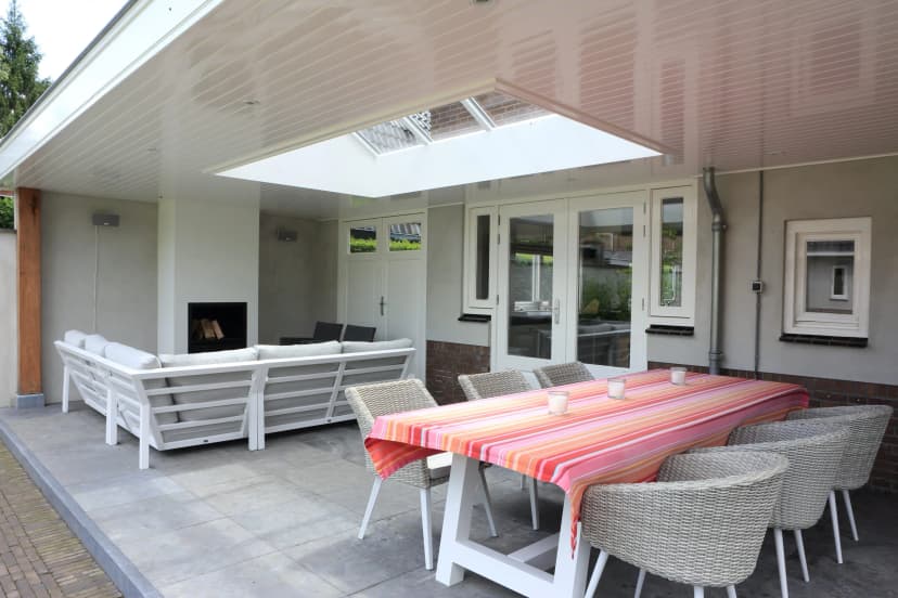 Interior view of covered terrace with seating and dining area