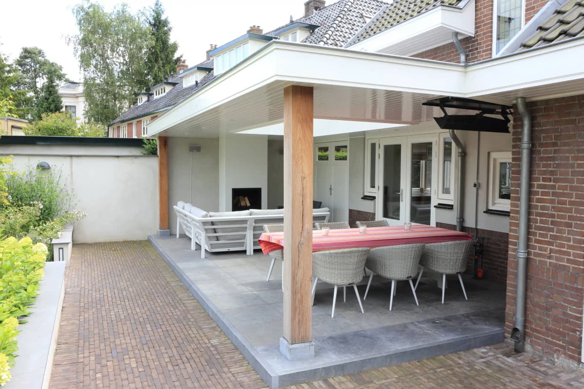 Covered outdoor terrace with modern furniture and fireplace
