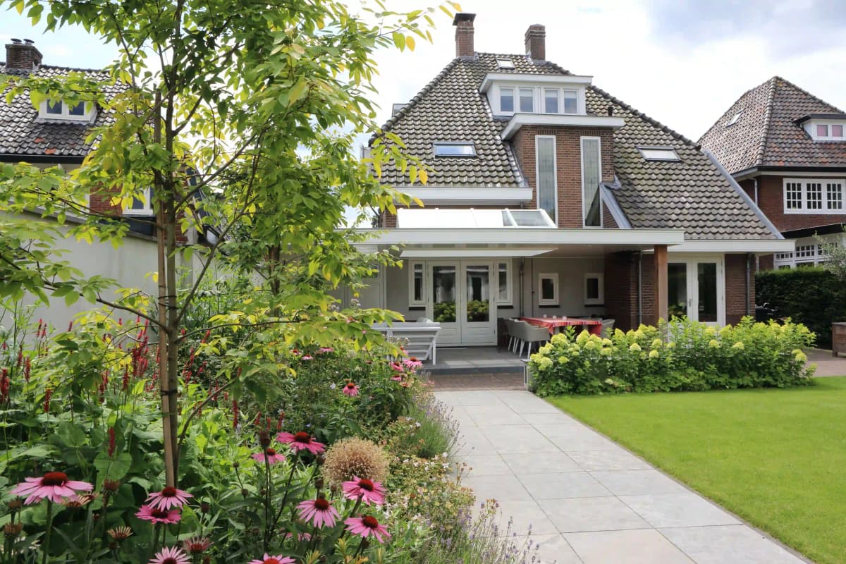 Wide view of garden border with perennials and modern backdrop